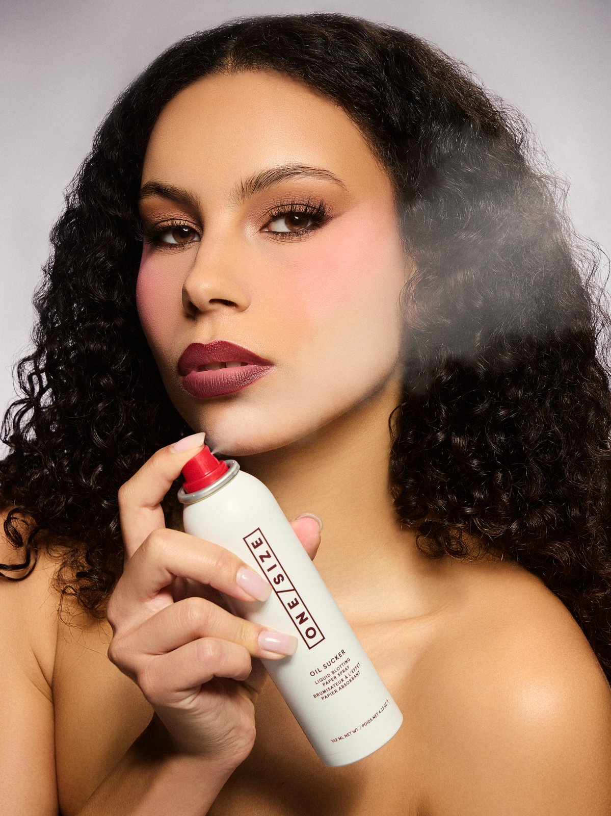 Beauty campaign editorial makeup with winged liner and mauve lips