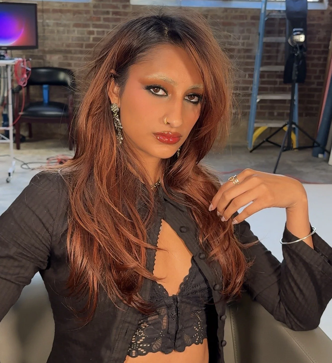 Bold editorial glam with warm bronze smoky eye and bleached brows